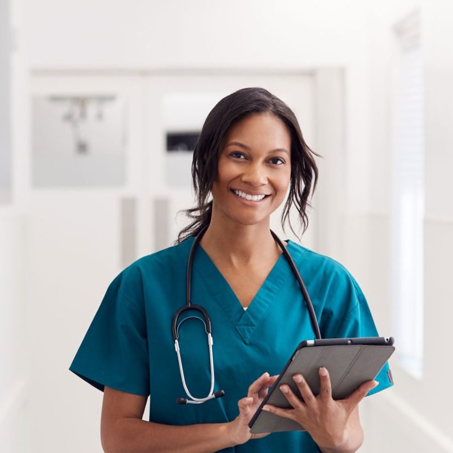 portrait-of-smiling-female-doctor-wearing-scrubs-KLLFEZS-1.jpg